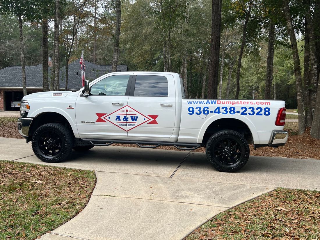 A&W Dumpster Rentals branded truck parked in a driveway