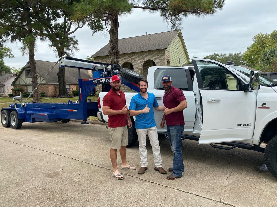 The A&W Dumpster Rentals crew with the truck and roll-off trailer